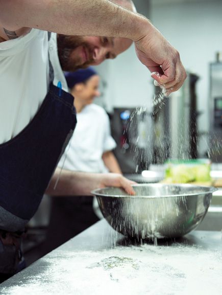 chef sprinkling flour